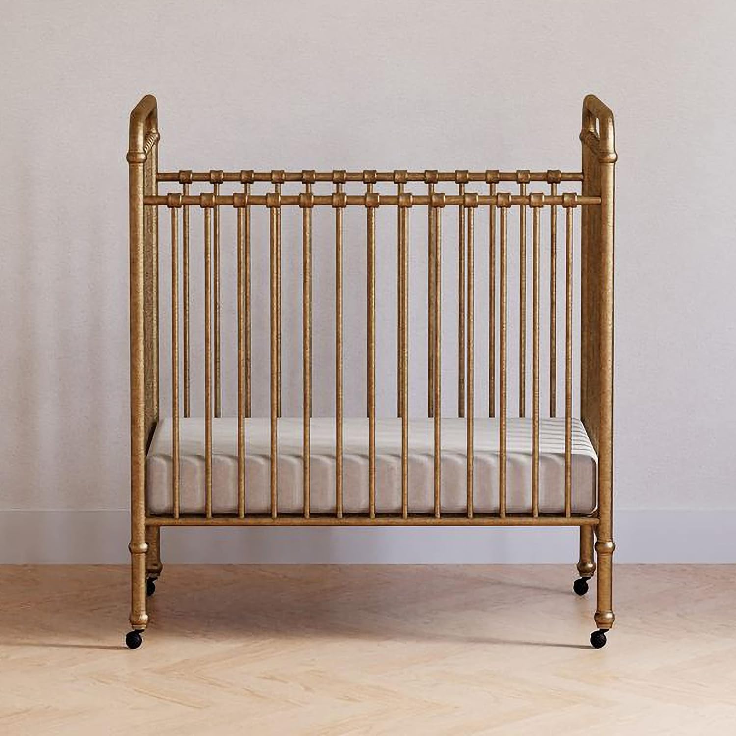 NAMESAKE Abigail 3-in-1 Portable Baby Crib with Wheels - Metal Baby Bed w/ 4 Adjustable Mattress Heights, for Small Spaces - Gold NAMESAKE Abigail 3-in-1 Portable Baby Crib with Wheels - GREENGUARD Gold Certified Convertible Crib to Toddler Bed & Daybed - Metal Baby Bed w/ 4 Adjustable Mattress Heights, for Small Spaces - Gold