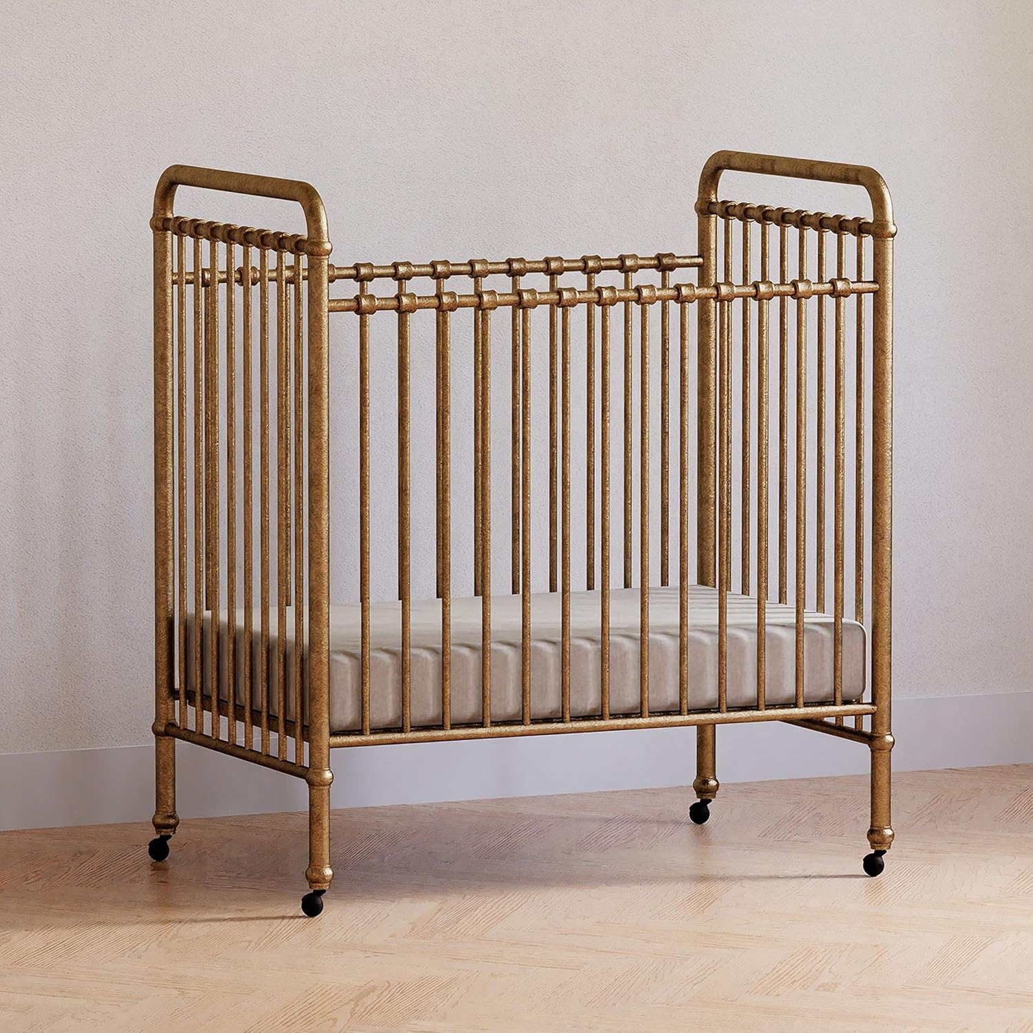NAMESAKE Abigail 3-in-1 Portable Baby Crib with Wheels - Metal Baby Bed w/ 4 Adjustable Mattress Heights, for Small Spaces - Gold NAMESAKE Abigail 3-in-1 Portable Baby Crib with Wheels - GREENGUARD Gold Certified Convertible Crib to Toddler Bed & Daybed - Metal Baby Bed w/ 4 Adjustable Mattress Heights, for Small Spaces - Gold