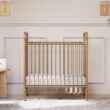 NAMESAKE Abigail 3-in-1 Portable Baby Crib with Wheels - Metal Baby Bed w/ 4 Adjustable Mattress Heights, for Small Spaces - Gold NAMESAKE Abigail 3-in-1 Portable Baby Crib with Wheels - GREENGUARD Gold Certified Convertible Crib to Toddler Bed & Daybed - Metal Baby Bed w/ 4 Adjustable Mattress Heights, for Small Spaces - Gold