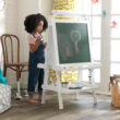 KidKraft Deluxe Wooden Easel with Chalkboard and Dry Erase Surfaces, Paper Roll and Paint Cups - White