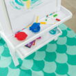 KidKraft Deluxe Wooden Easel with Chalkboard and Dry Erase Surfaces, Paper Roll and Paint Cups - White
