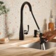 Moen Essie Matte Black Single Handle Deck-mount Touchless Pull-down Kitchen Faucet with Sprayer (Includes Deck Plate) (Includes Soap Dispenser) Moen Essie Matte Black Single Handle Deck-mount Touchless Pull-down Kitchen Faucet with Sprayer (Includes Deck Plate) (Includes Soap Dispenser)