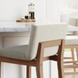 Nathan James Gracie Modern Counter Height Bar Stool with Back, Counter Stool Upholstered Chair with Natural Flax White Fabric and Brushed Light Brown Wooden Legs, Natural Flax/Brown